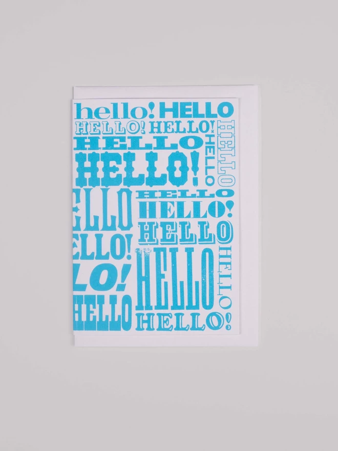 Blue Greetings Card with Hello written all over it in different fonts