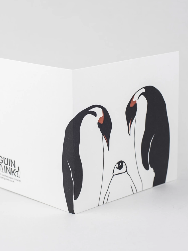 Penguin family card stood up showing the wrap around of the design to the bck of the card