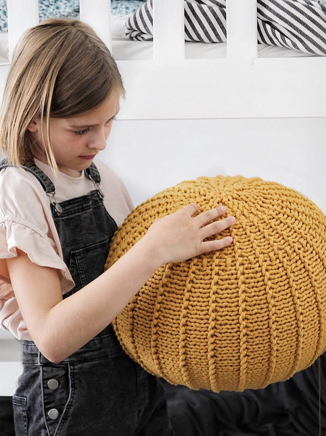 small pouffe in mustard colour
