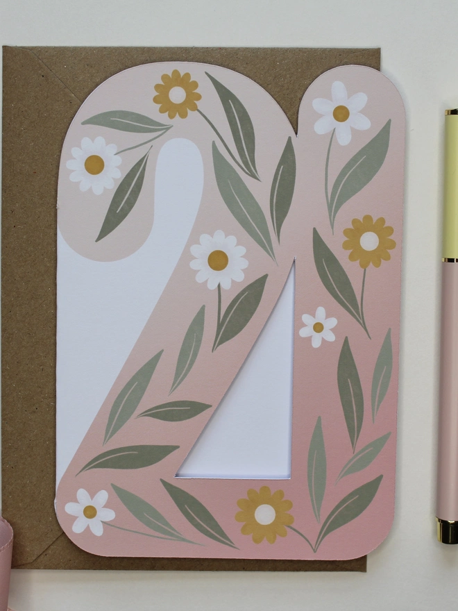 floral 21st birthday card. card shaped like number 21 with illustrated flowers and leaves.