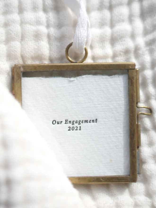 Personalised Our Engagement Hanging Frame. Letterpress printed 'our engagement' with a date on white paper in a bronze hanging frame.