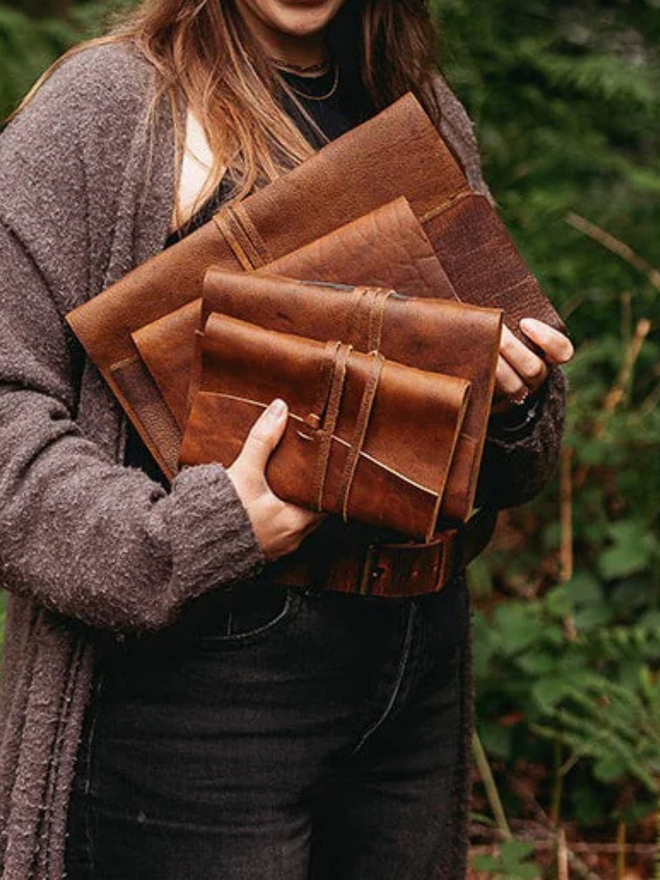  leather refillable ring binder. a stack of light brown ring binders.