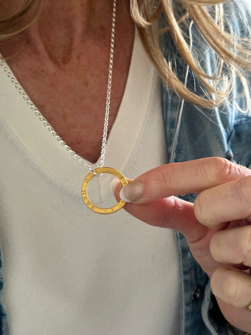 model wears personalised gold plate circle charm on sterling silver chain
