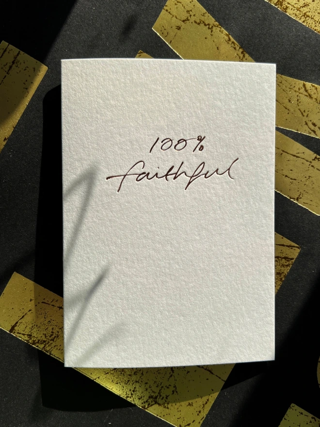 handfoiled luxury card that has 100% faithful written on the front stamped in rose gold foil - inspired by the hit BBC show The Traitors