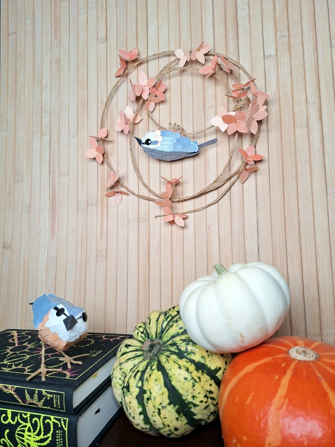 nuthatch bird sculpture on a peach hydrangea wreath