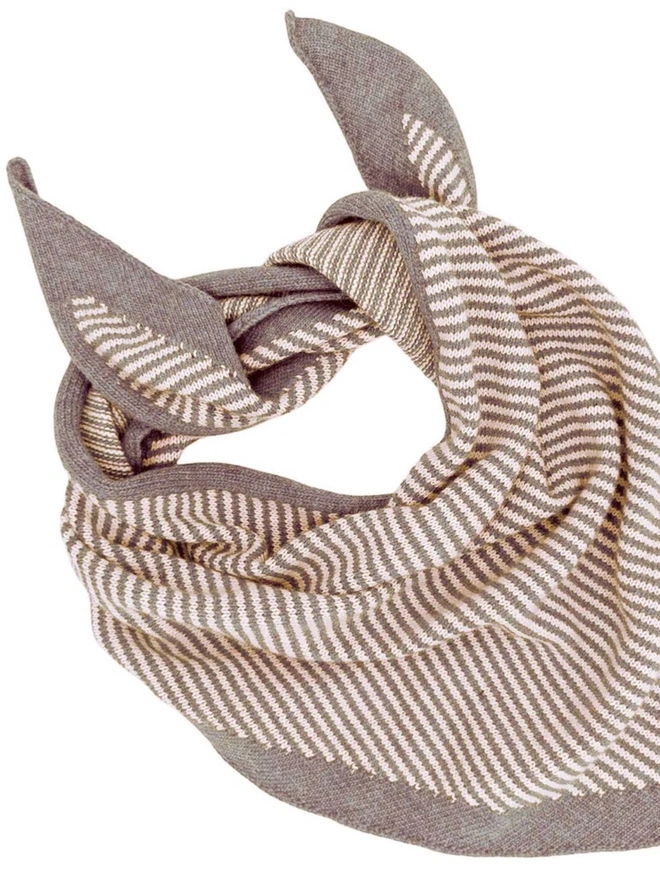 Lambswool Triangle Neck Scarf, a colourful neck scarf sitting on a white plain surface. 