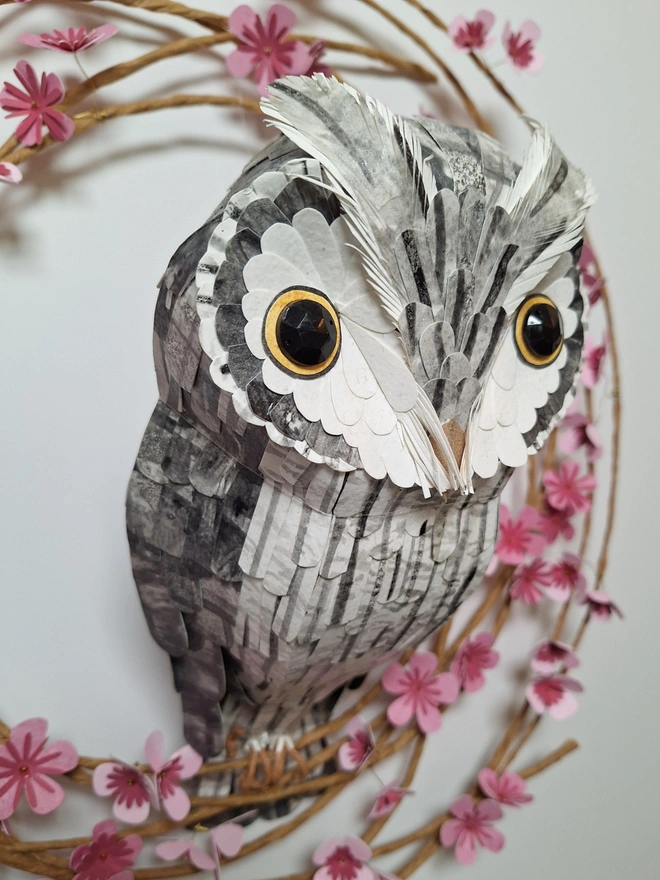 close up of a white faced owl handmade paper sculpture