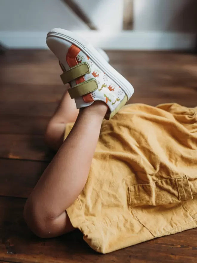 Little girl in a yellow dress wearing Pip and Henry White Safari Sneakers