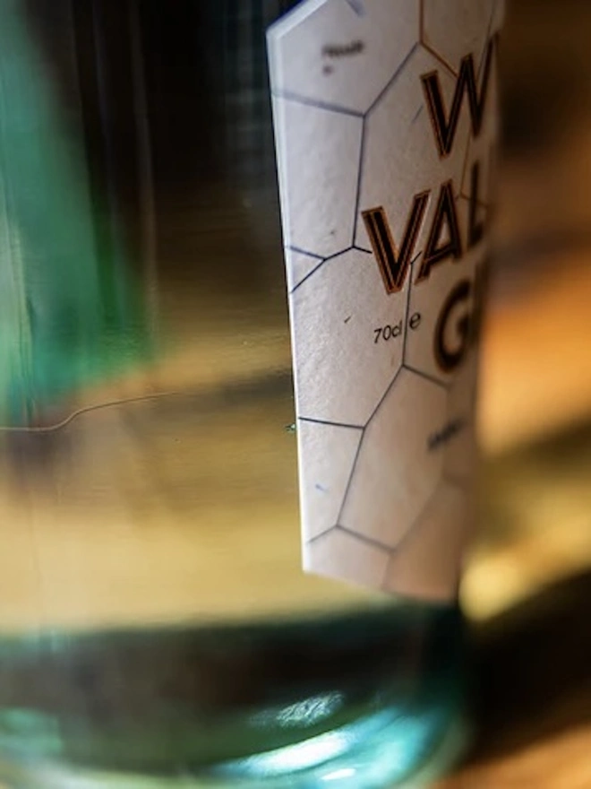  Wye Valley Gin, bottle of spirit on a wooden table. 