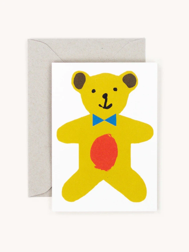 white card with brightly coloured yellow teddy bear 