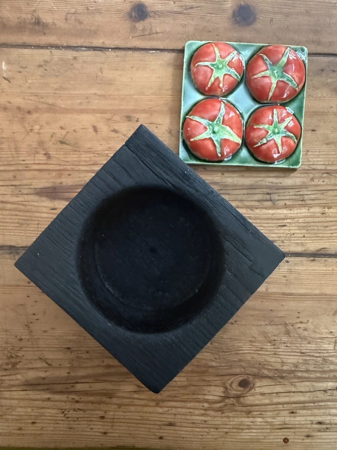 Charred black oak pots with tomato ceramic til lid