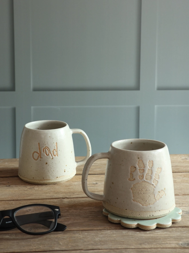 Handmade Stoneware Ceramic Mug glazed in which with Dada written on the front in a child's handwriting. 