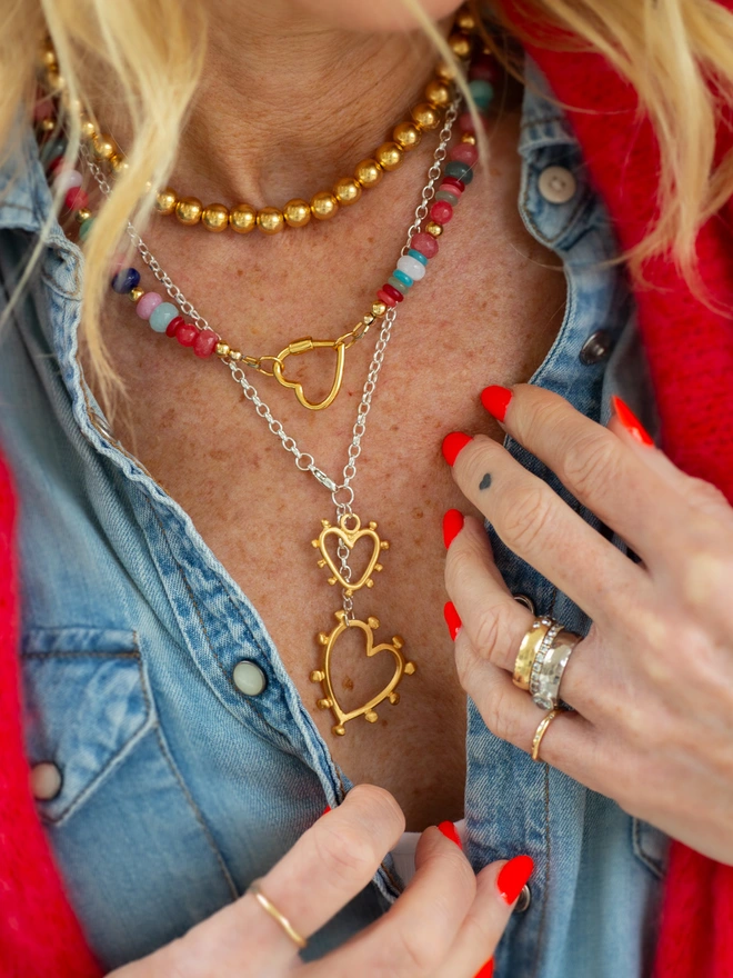 The Belong Together Lariat Necklace blends bold design with timeless sentiment. Two textured studded hearts in contrasting sizes hang from a graceful Y-style chain, creating a mixed metal statement necklace that feels strong, feminine and beautifully personal. Designed for everyday wear and lasting meaning.