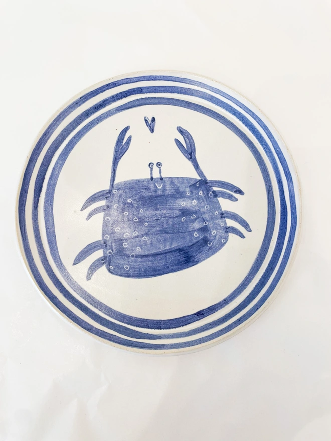 blue and white crab side plate on a white background