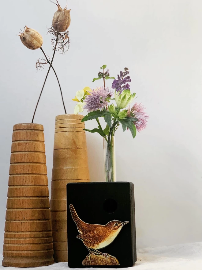 A tiny wren on a recycled wood block, painted black with a glass test tube bud vase