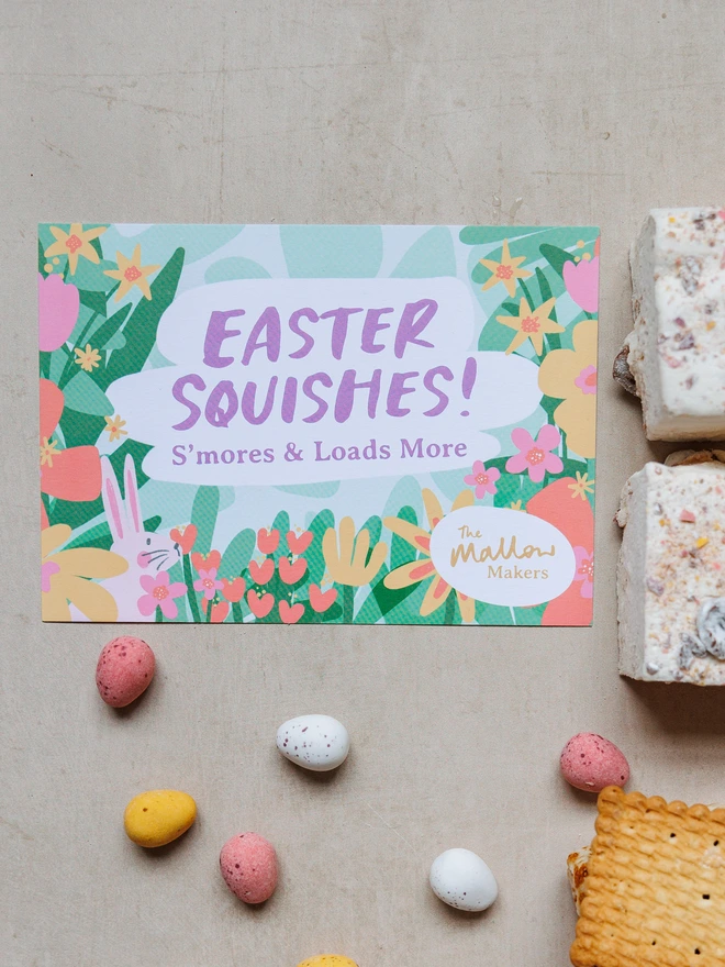looking down on an illustrated postcard of Easter Squishes surrounded by cadbury mini eggs and marshmallows