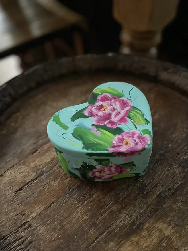 hand painted floral ceramic heart shaped keepsake box background in a pale blue with pink peony flowers