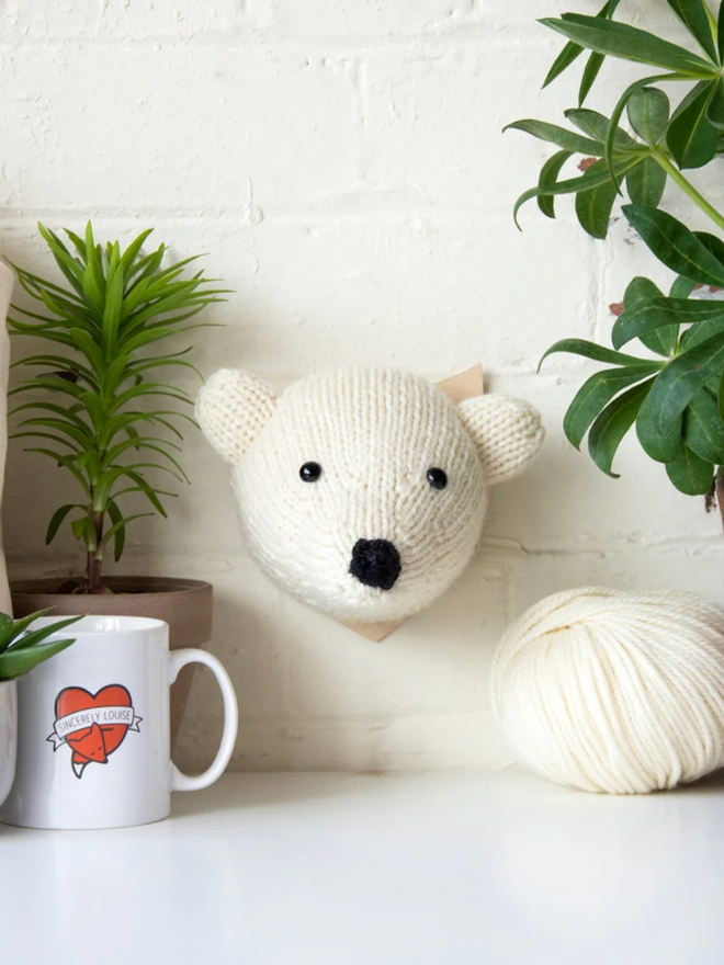 Bear Head Knit Kit. A mini polar bear head, completed and mounted.
