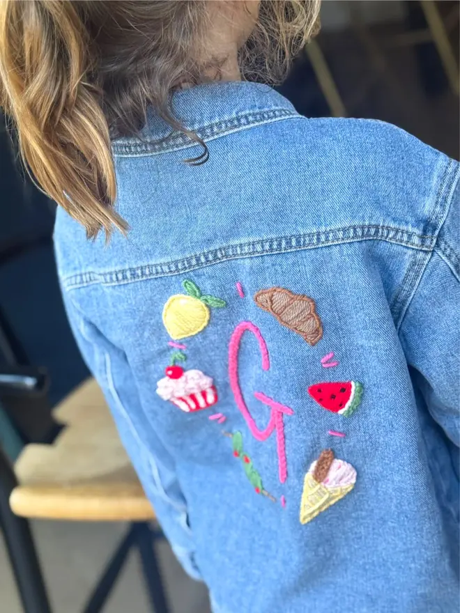 Girl wearing hand-embroidered denim jacket