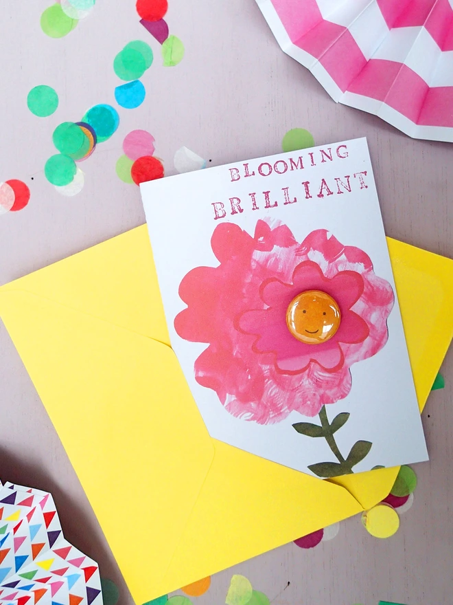 brilliant pink flower greeting card with happy face pin badge