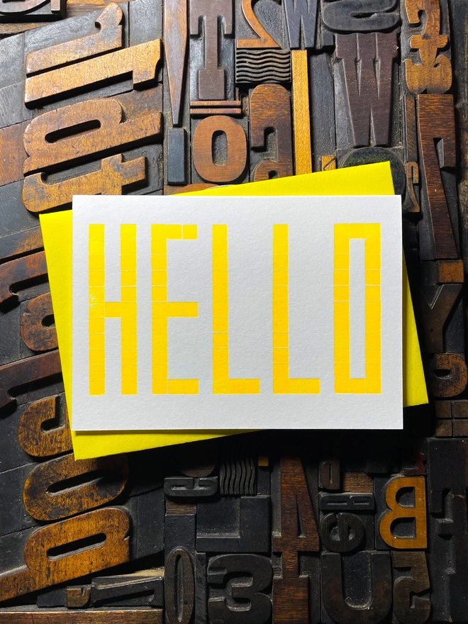 A card to just say HELLO and send to family and your friends.   Made from a grid of square wooden type blocks. Printed using fluorescent yellow ink with a deep impression print. Luxurious Colorplan Pristine White thick 350gsm double-sided card.