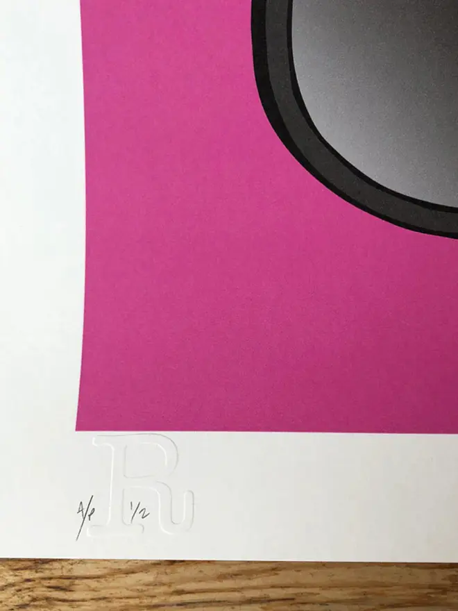 Motor cycle helmet with a star-and-stripe design on a pink background. 