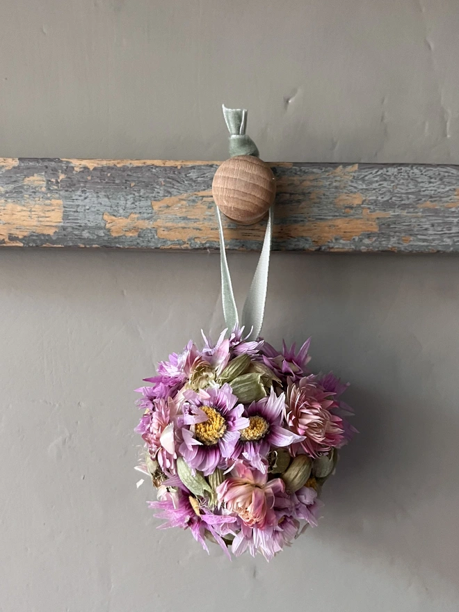 Pink and Green Dried Flower Bauble. A bauble made of dried seasonal flowers.