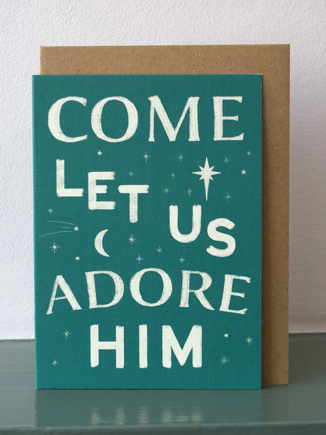 Green Christmas card with carol words from 'O come all ye faithful'