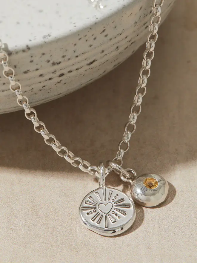 Silver Darling Heart Pebble Necklace close up image with a birthstone charm