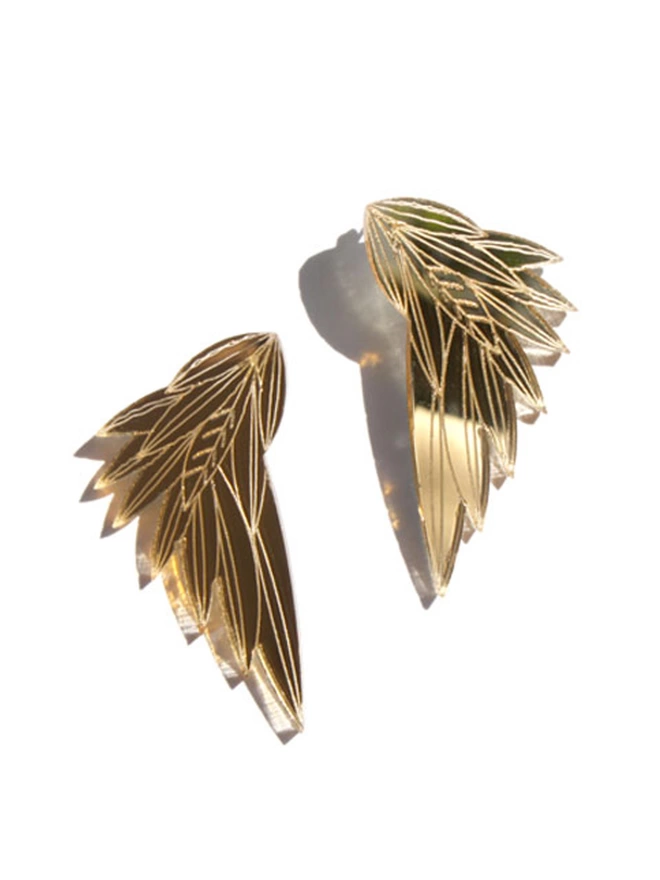 Wing structured Earrings made from gold acrylic with intricate etchings.