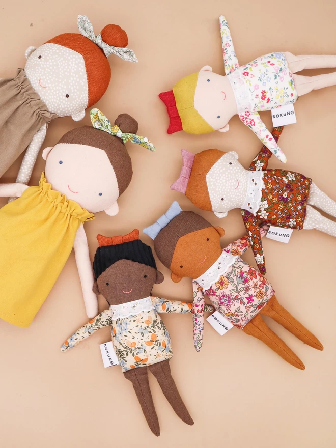 diverse collection of little sister dolls and big sister dolls