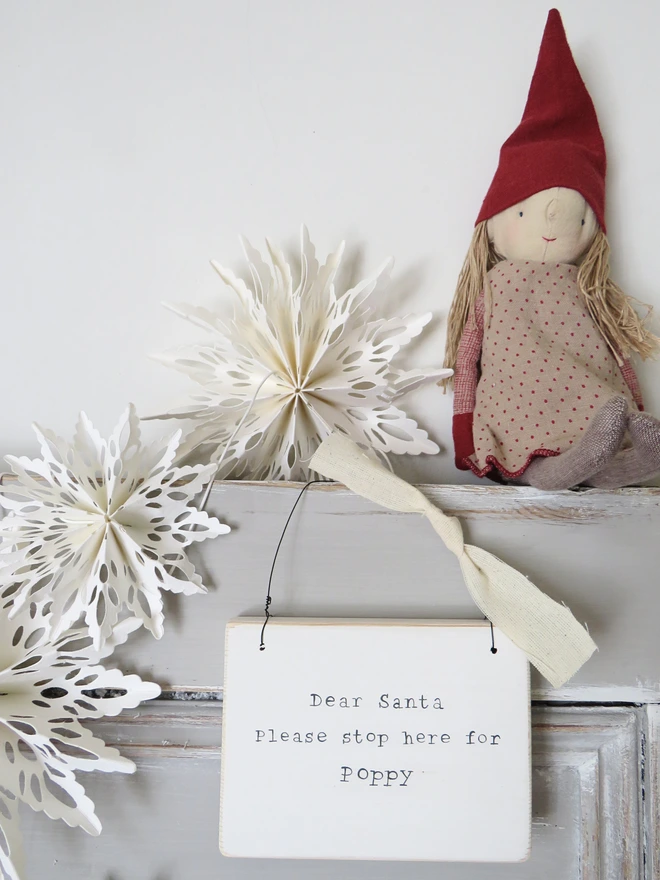 Chalky white painted wooden hanging sign with hand painted personalised Dear Santa message