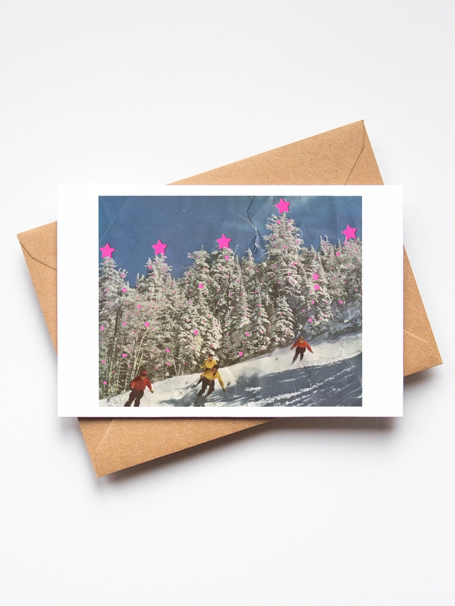 A retro christmas card with a snowy skiing scene. The trees lining the mountain are decorated in bright neon colours.