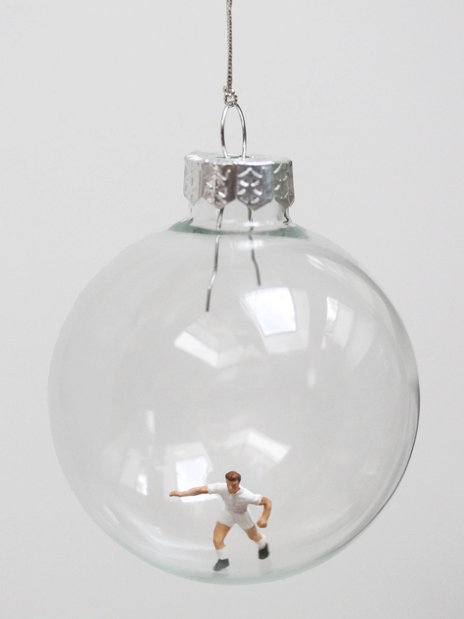 miniature football figure in a glass christmas bauble