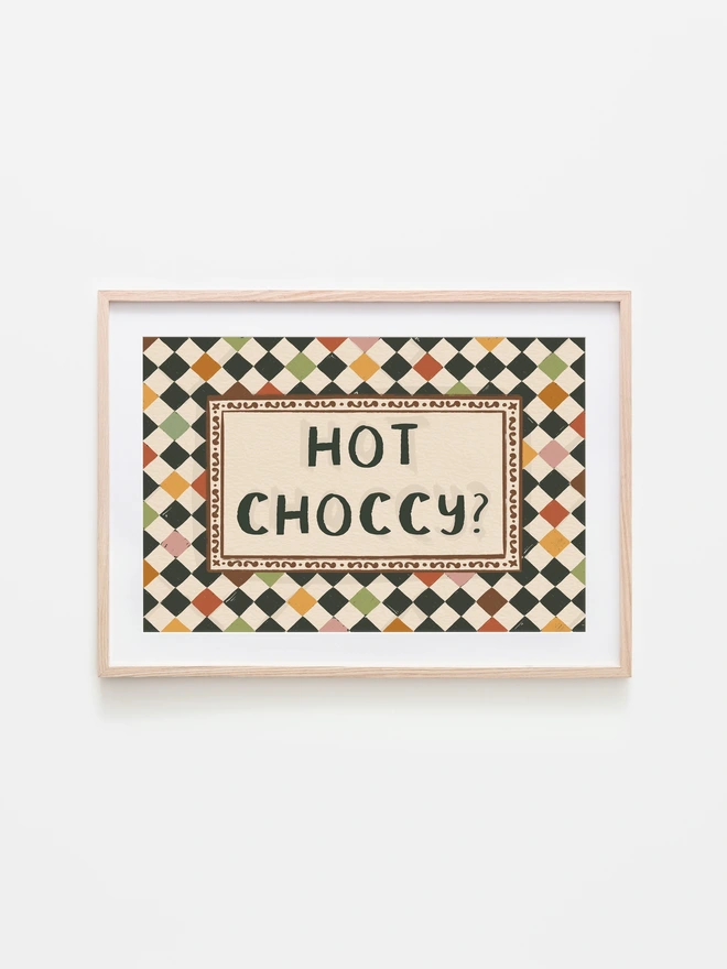 Checkerboard pattern with ' Hot Choccy?' text central, featuring a rich chocolate and jewel tone inspired colour palette, with a  harlequin check tile background. 
