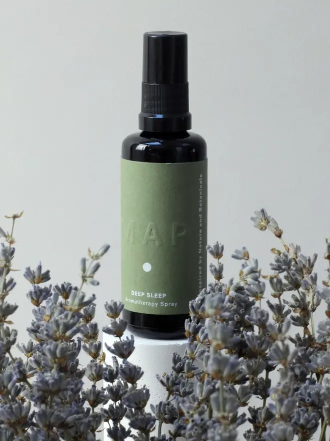 deep sleep lavender and vetiver home fragrance spray. spray bottle photographed amongst lavender. 