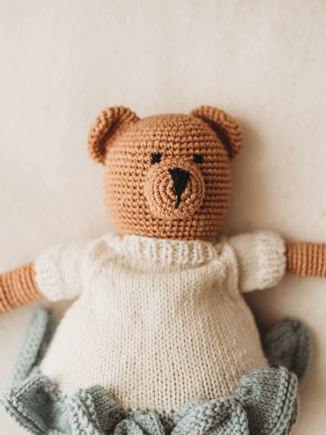 hand crochet brown teddy bear wearing hand knit blue and white dress