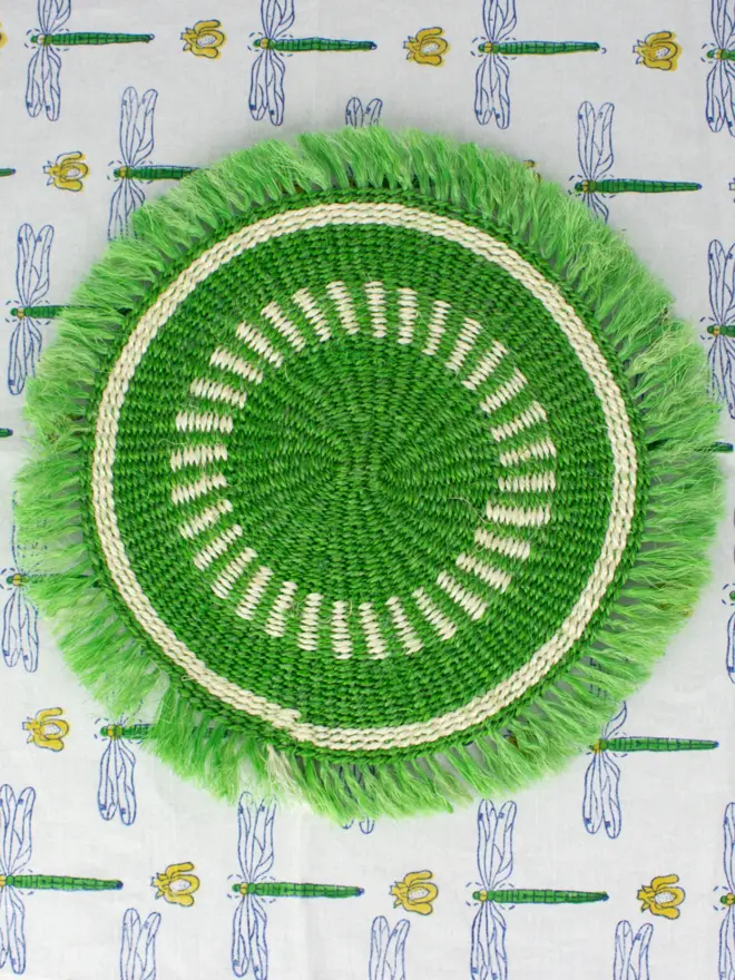 Green placemat on patterned tablecloth