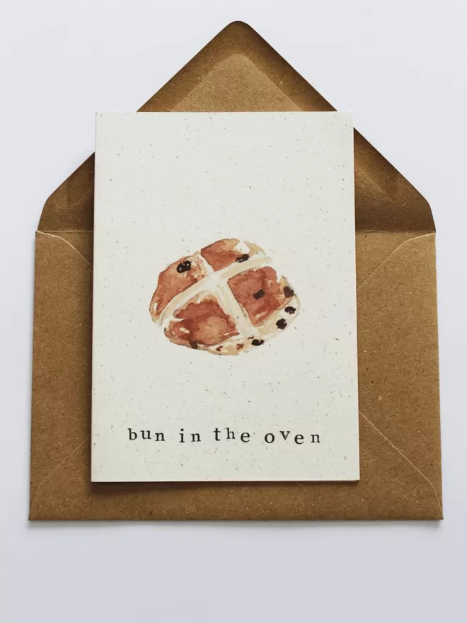 'Bun In The Oven' Card laying on Kraft envelope