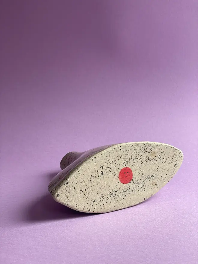 Love Potion/ Poison Bottle Vase, a vase that says 'love poison' in front of a purple backdrop. Each is stamped with a signature red dot on the bottom. 