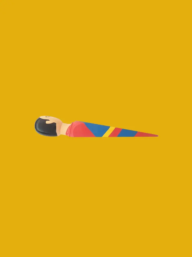 Wooden Door Stopper (Super Wedgie), a colourful wooden door stop on a yellow background