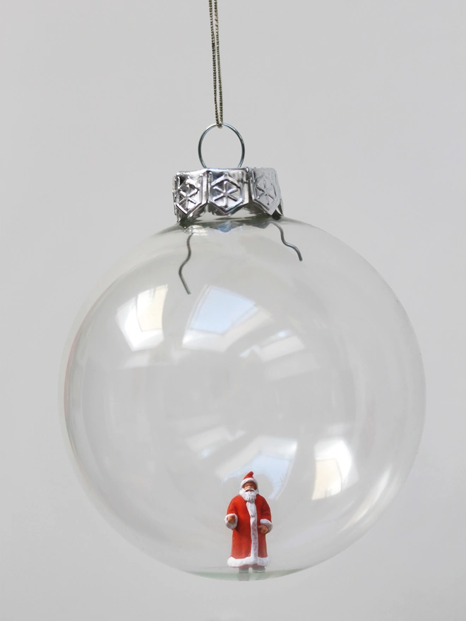 Miniature figure of Santa in a glass hanging christmas bauble 