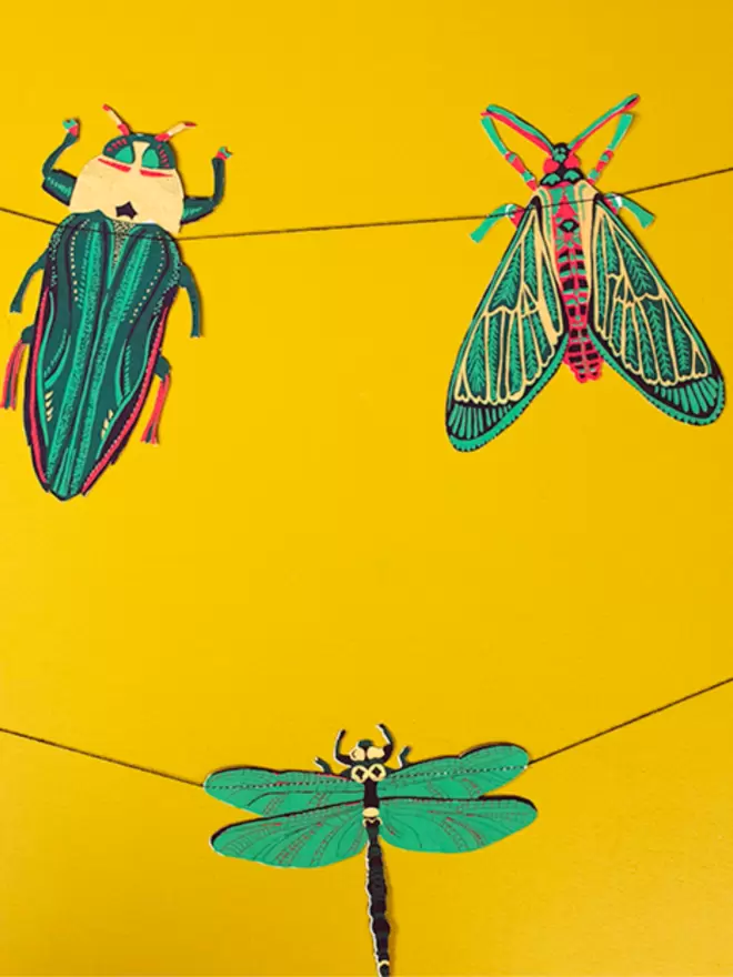 3 insect designs matching colours of green, yellow and gold.