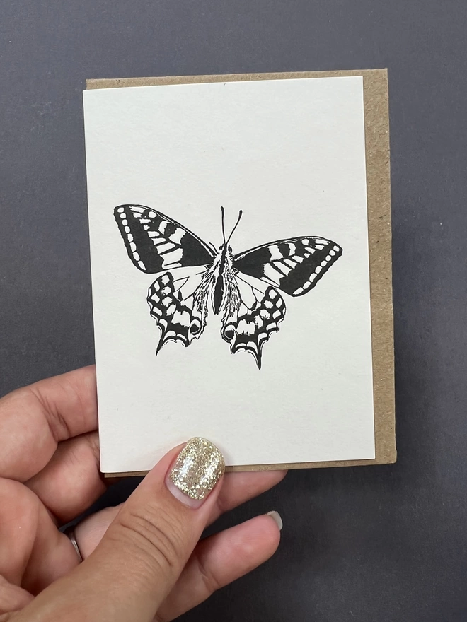 The detailed Swallowtail butterfly design on the small card