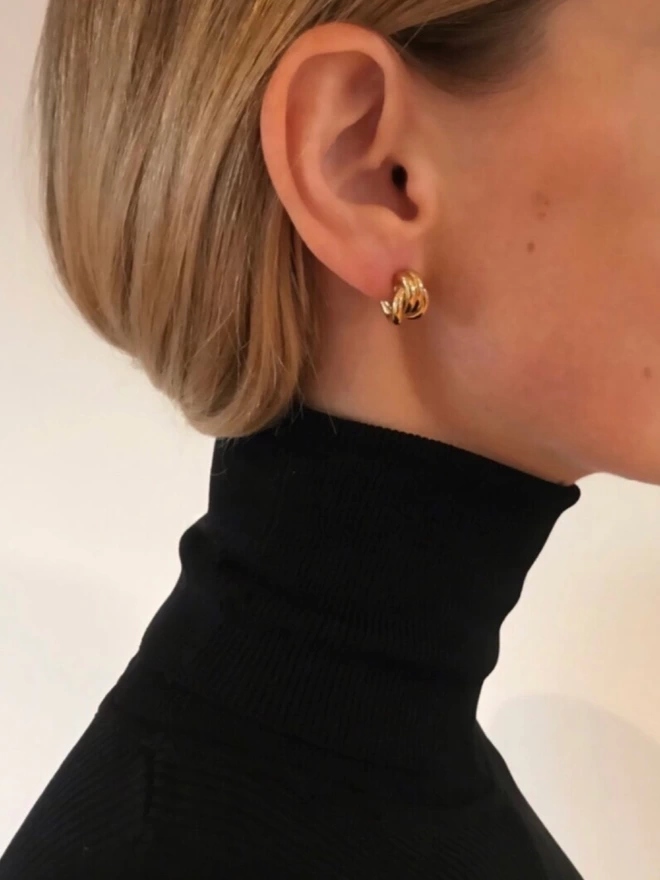 minimal, contemporary gold earrings, perfect for everyday wear. knotted design curves perfectly behind earlobe for extra comfort