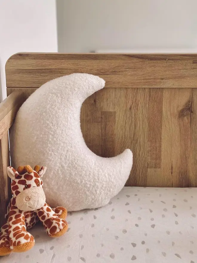 boucle moon pillow. a moon shaped pillow cushion in cream.