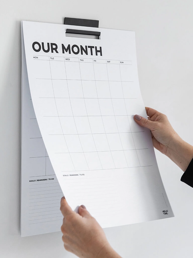 Year Wall Planner hanging on the wall, hand on sheet