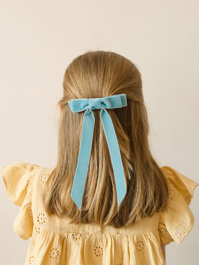 Girl in yellow dress and light blue velvet hair bow clip