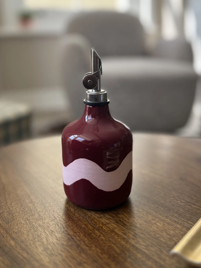 sangria burgundy with pink wave oil bottle