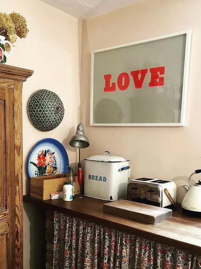 Love Screen print seen in a kitchen.